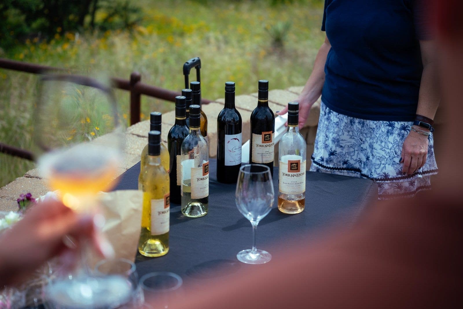 Romantic proposal setup with wine bottles and table decor overlooking the Texas Hill Country in Austin.