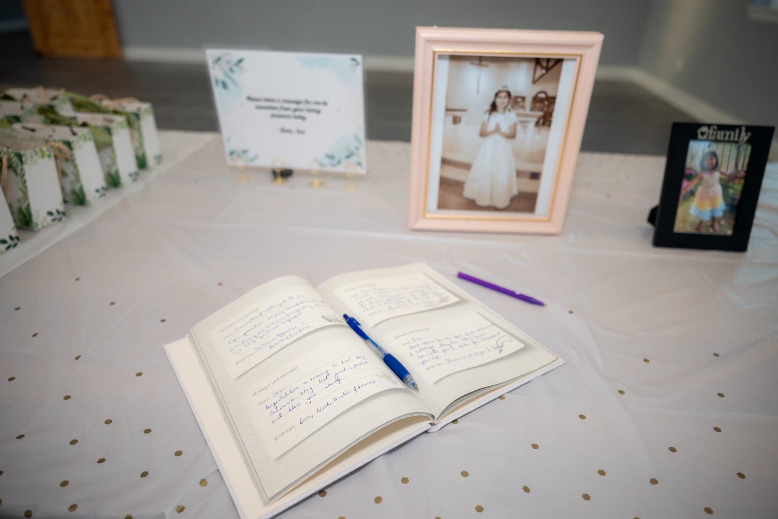 First Communion celebration table setup with guest message book, framed photos, and party favors, captured by Zan Visuals as part of professional event photography.