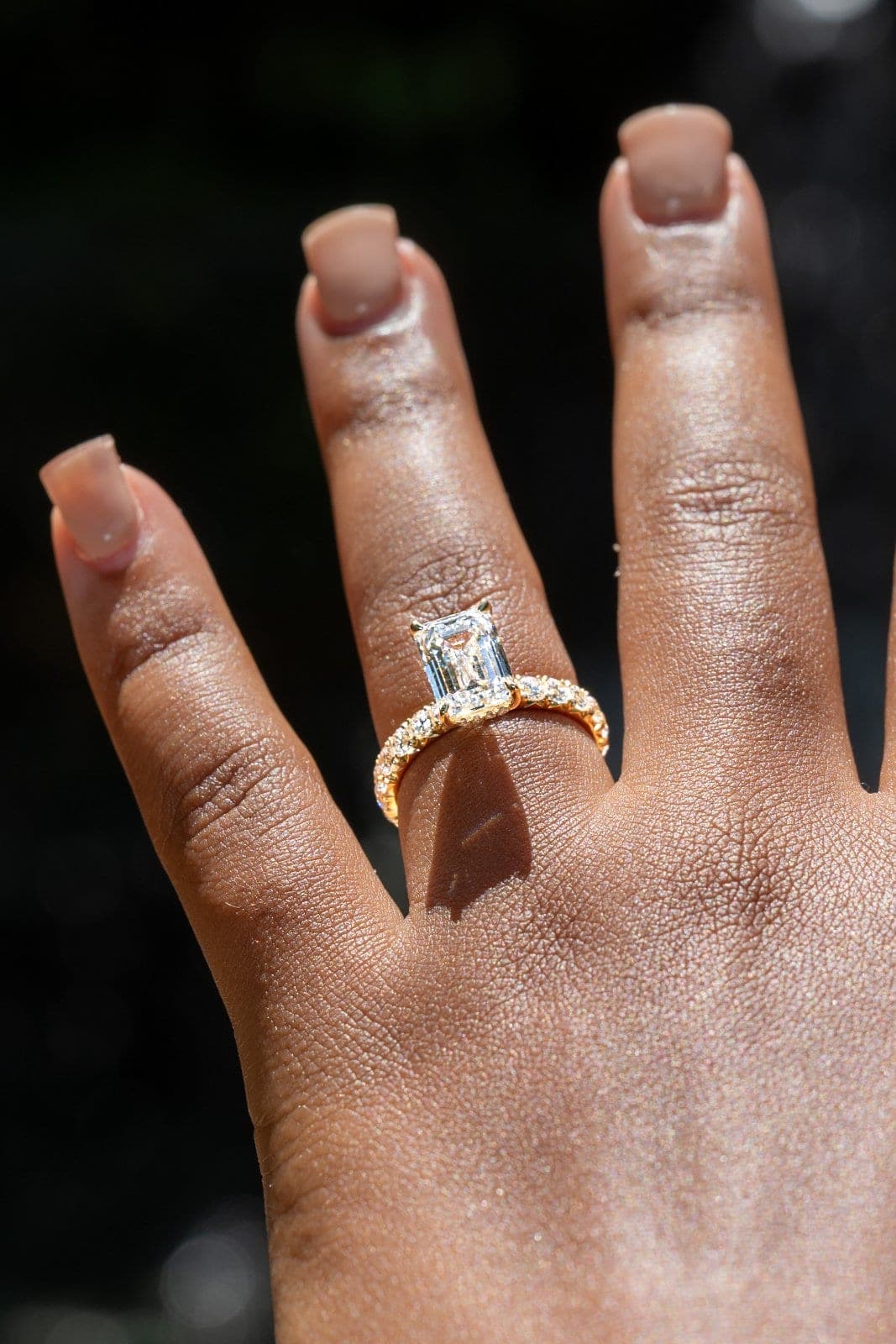 Close-up of a diamond engagement ring photographed outdoors in natural sunlight after an Austin proposal.