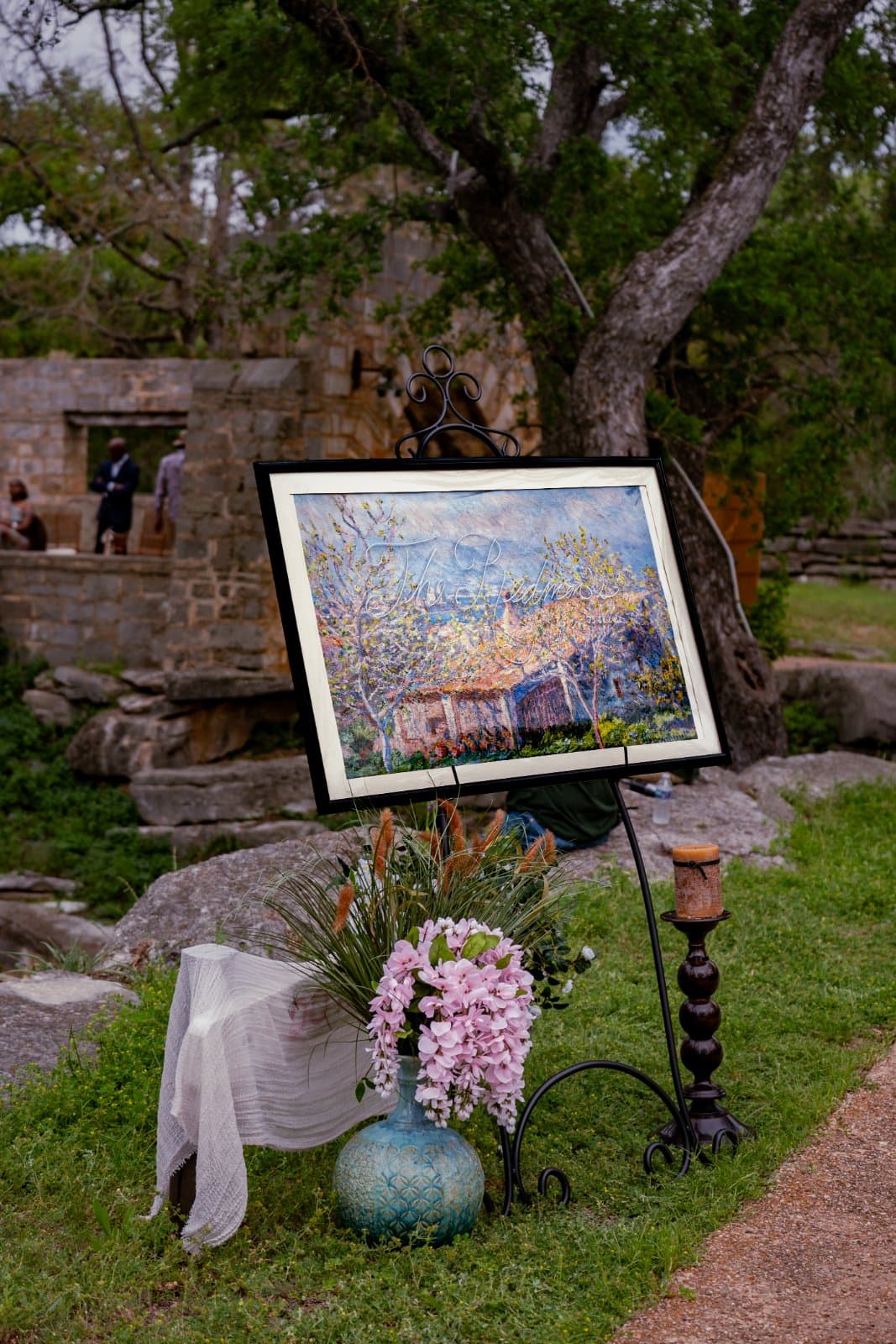 Elegant outdoor wedding ceremony details displayed on an easel in Burnet, Texas.