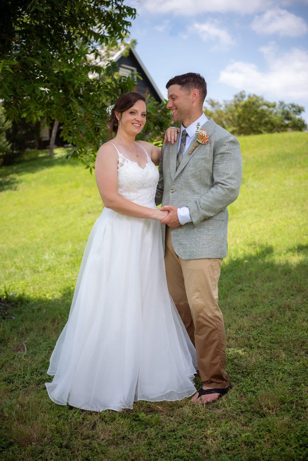 Bride and groom smiling together in their wedding attire during an outdoor portrait session in Central Texas.